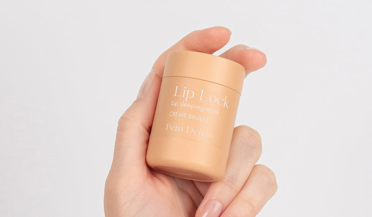 Pem Delian Lip Lock Créme Brulée éjszakai ajakápoló maszk kézben tartva