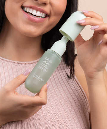 Pem Delian Glass Skin Ginseng & Centella toner a modell kezében, kupakját leveszi